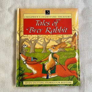 May include: A hardcover children's book titled "Tales of Brer Rabbit." The cover features an illustration of Brer Rabbit riding a fox through a forest scene. The book is part of the "Children's Storytime Treasury" series.