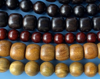 May include: A close-up of a set of wooden beads in various shades of brown, red, and natural wood. The beads are arranged in rows, creating a layered effect. The beads are smooth and polished, with a natural wood grain visible.