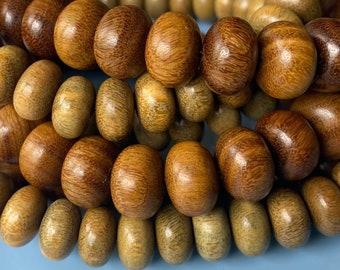 May include: A close-up of a wooden beaded necklace with brown and light brown beads. The beads are round and have a smooth, polished finish.