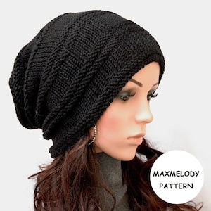 May include: A black knitted beanie with a cable knit pattern. The beanie is slouchy and has a long, flowing design. The beanie is worn by a person with long, dark hair.