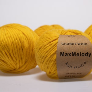 May include: Four balls of yellow chunky wool yarn, one with a brown label that reads "CHUNKY WOOL MaxMelody knit studio 100% Merino wool 100g 4.5oz Made in Australia"