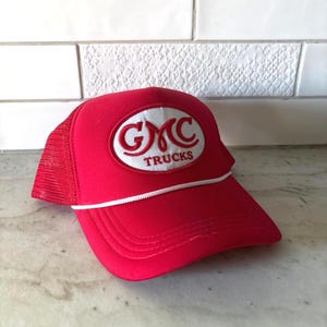 Cappellino da camionista rosso e bianco con toppa GMC Trucks e chiusura SnapBack con cordino.