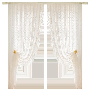May include: Cream-colored lace curtains with floral patterns. The curtains are draped and held with gold-colored star-shaped tiebacks. The sheer fabric allows light to filter through, creating a soft, airy ambiance. The curtains hang from a cream-colored rod.