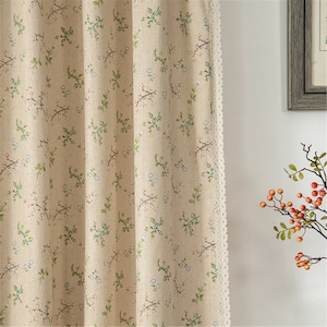 May include: Beige linen curtains with a white lace trim and a small floral pattern in shades of green, blue, and pink.