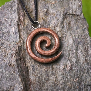 Small Spiral shaped wooden pendant made from English Walnut hung on a adjustable waxed Cotton Thong