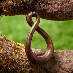 Small Wooden Celtic Knot pendant Made from English Walnut and hung on a adjustable waxed cotton thong