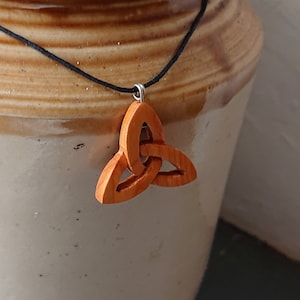 Handmade Celtic Trinity Knot pendant made from Windfallen Irish Yew,hung on a adjustable waxed cotton thong