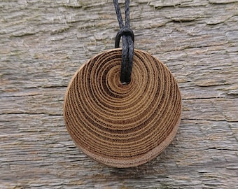 Round wooden pendant made from Laburnum and hung on a adjustable Waxed Cotton Thong