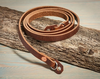 Hand made chestnut leather camera strap with copper rivets.