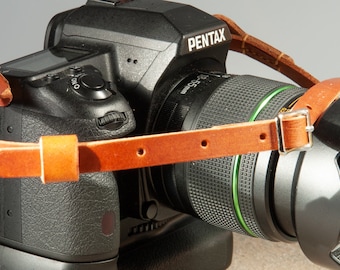 Hand made English leather adjustable camera strap with retaining loops.