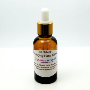 May include: A brown glass bottle with a gold lid and a white dropper top. The bottle is labeled "All Natural Anti-Aging Face Serum" and "NANA'S NATURALS Products Made with Love". The label also lists ingredients including Jojoba Oil, Vitamin E Oil, Rosehip Oil, Frankincense, Patchouli, Lavender and Helichrysum Essential Oils.