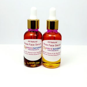 May include: Two amber glass bottles with gold caps and droppers filled with a clear liquid. The bottles are labeled "All Natural Rose Face Serum" and "NANA'S NATURALS Products Made with Love".