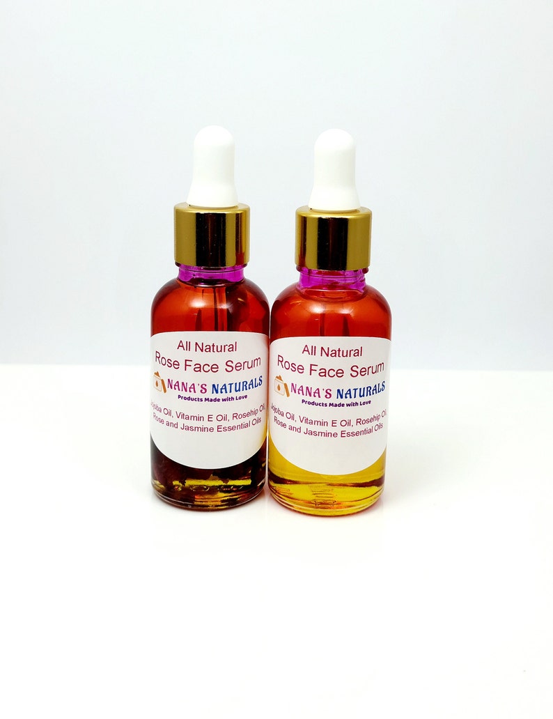 May include: Two amber glass bottles with gold caps and droppers filled with a clear liquid. The bottles are labeled "All Natural Rose Face Serum" and "NANA'S NATURALS Products Made with Love".