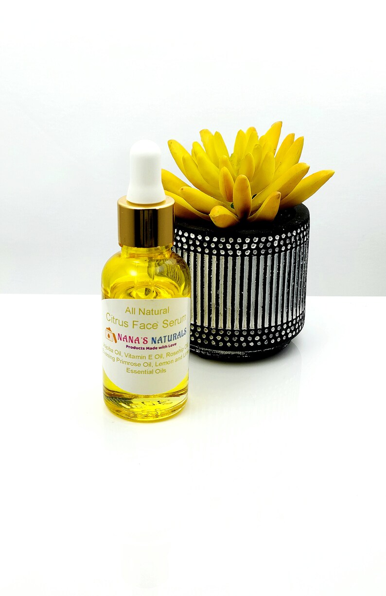 May include: A glass bottle of citrus face serum with a gold lid and dropper. The bottle is labelled "All Natural Citrus Face Serum" and "NANA'S NATURALS Products Made with Love". The ingredients listed are Evening Primrose Oil, Lemon and Lime Essential Oils, Vitamin E Oil, Rosehip Oil.