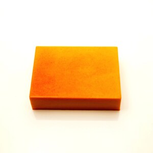May include: A rectangular bar of orange soap.