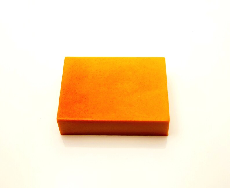 May include: A rectangular bar of orange soap.