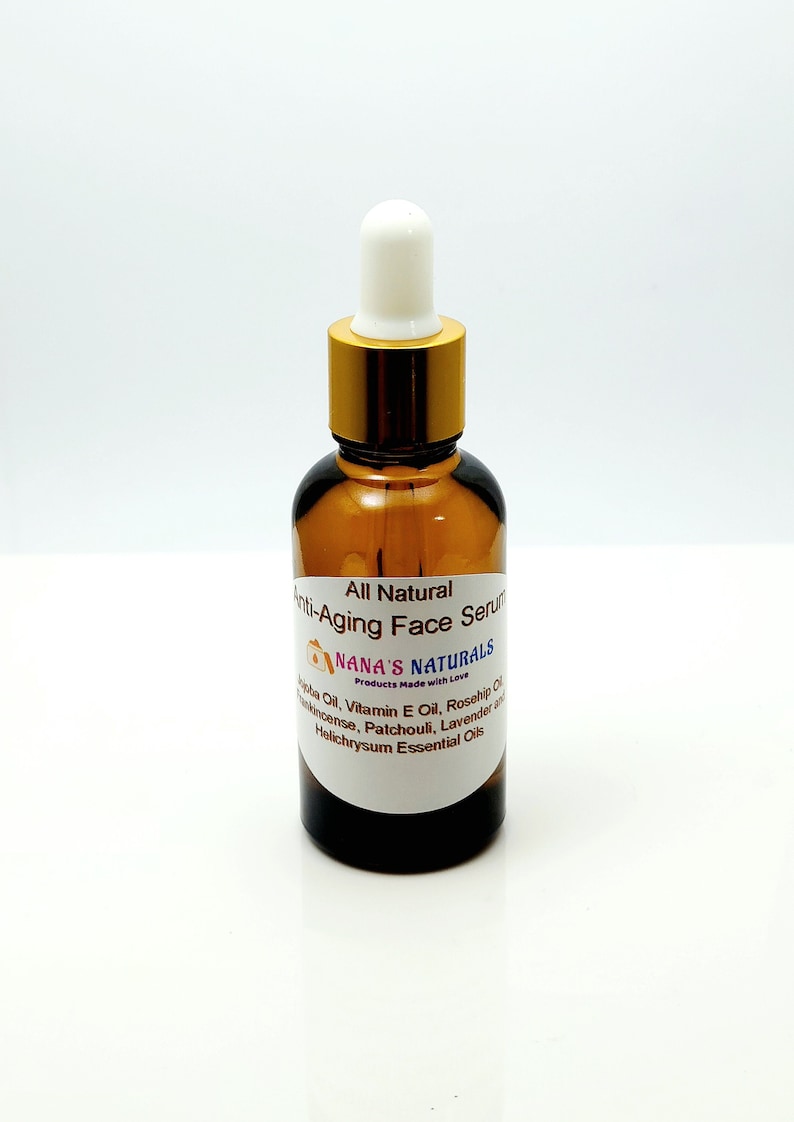 May include: A brown glass bottle with a gold lid and a white dropper top. The bottle is labeled "All Natural Anti-Aging Face Serum" and "NANA'S NATURALS Products Made with Love". The label also lists ingredients including Jojoba Oil, Vitamin E Oil, Rosehip Oil, Frankincense, Patchouli, Lavender and Helichrysum Essential Oils.