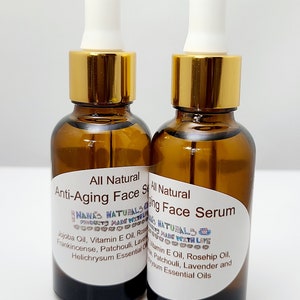 May include: Two amber glass bottles with gold lids and white droppers filled with a clear liquid. The bottles have white labels with black text that reads "All Natural Anti-Aging Face Serum" and "NANA'S NATURALS PRODUCTS MADE WITH LOVE".
