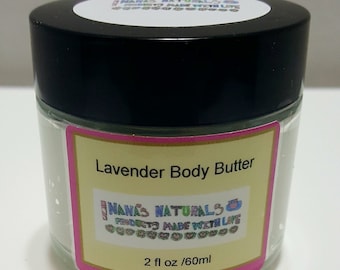 May include: A white jar with a black lid containing lavender body butter. The jar has a pink and yellow label that reads "Lavender Body Butter" and "Nanas Naturals Products Made With Love". The label also includes the size of the jar, "2 fl oz / 60ml".