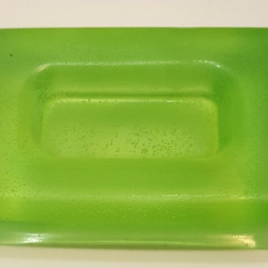 May include: A light green rectangular soap dish with a slightly raised rectangular area in the centre.