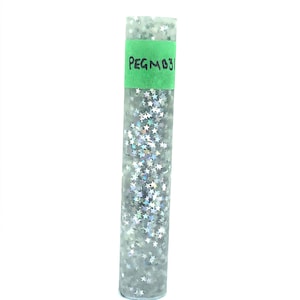 May include: A clear plastic tube filled with silver holographic star-shaped glitter. A green label on the tube reads "PEGMO31".