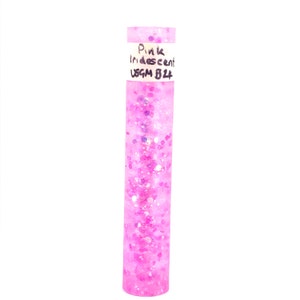 May include: A clear tube filled with pink iridescent glitter. The label on the tube reads "Pink Iridescent USGM B24".