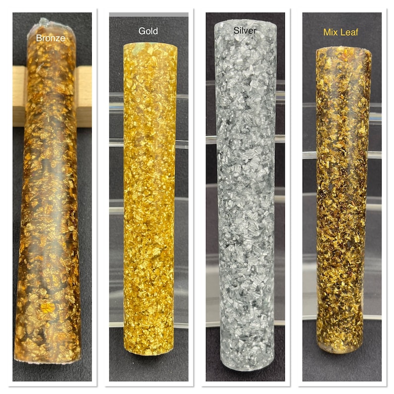May include: Four cylindrical resin samples with different metallic flakes embedded in clear resin. The samples are labeled "Bronze", "Gold", "Silver", and "Mix Leaf".
