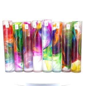 May include: Eight clear tubes filled with colorful resin and feathers. The tubes are numbered 1 through 8.