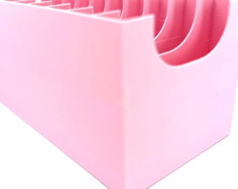 May include: A pink plastic organizer with multiple compartments for storing small items.