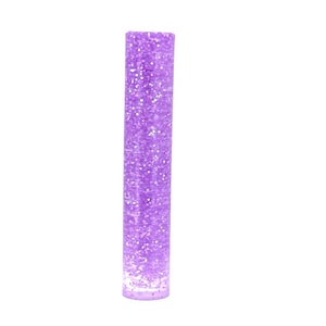 May include: A purple glitter filled tube with a clear plastic exterior.