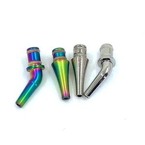 May include: Four different coloured metal tips for a vape pen. The tips are all different shapes and sizes. The tips are made of metal and have a shiny finish.
