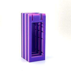 May include: A purple and pink 3D printed storage box with a rectangular opening. The box has a striped pattern.