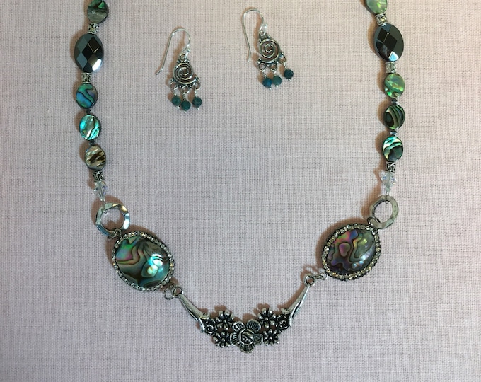 Single strand necklace with pewter focal element, abalone, and hematite