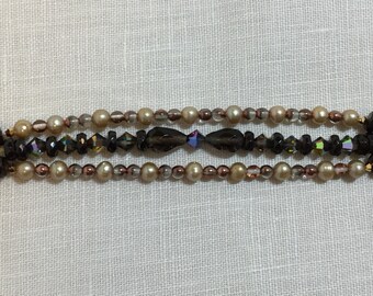 Triple strand charm bracelet, garnets, pearls, and crystals