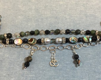 Triple strand charm bracelet with abalone, jade, and pearls
