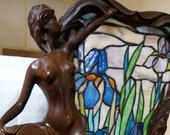 Stained glass leaded lamp with art noveau nude figurine. The stained glass is of flowers green blue leaves. in working order. Pat tested