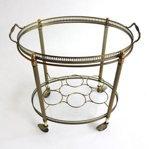 Vintage Gilt Metal Oval Bar Cart Hollywood Regency Glass Trolley Removable Tray & Bottle Rack In The Style of Maison Jansen France ca. 1940s