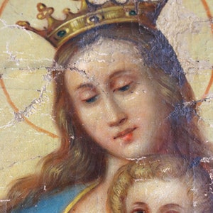 May include: A painting of a woman wearing a gold crown and a blue robe, holding a child. The woman has long, flowing hair and a gentle expression. The child is looking up at the woman with a sweet smile.