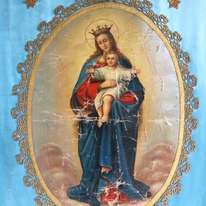 May include: A vintage painting of the Virgin Mary holding a baby Jesus. The painting is framed in a gold oval with a decorative border. The background is a light blue.
