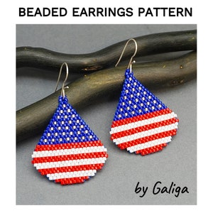 May include: A pair of beaded earrings shaped like teardrops, with a blue, white, and red design resembling the American flag. The earrings are hanging from silver hooks. The text "by Galiga" is visible below the earrings.