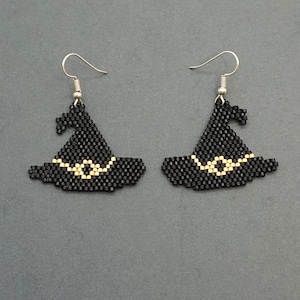May include: A pair of black witch hat earrings with gold trim. The earrings are made of beads and have silver hooks.