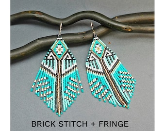 May include: A pair of turquoise, white, black and gold beaded fringe earrings. The earrings are made with brick stitch and feature a geometric pattern. The earrings are hanging from a branch.