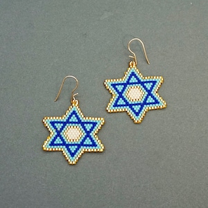 May include: A pair of gold earrings with blue and white beaded Star of David charms.