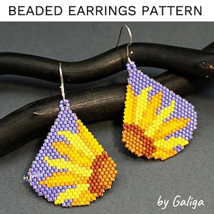 Peut inclure: Une paire de boucles d'oreilles en perles de forme goutte. Les boucles d'oreilles sont faites de perles violettes, jaunes et orange. Les boucles d'oreilles sont suspendues à des crochets argentés. Les boucles d'oreilles sont sur un fond en bois noir. Le texte "by Galiga" est visible dans le coin inférieur droit de l'image.