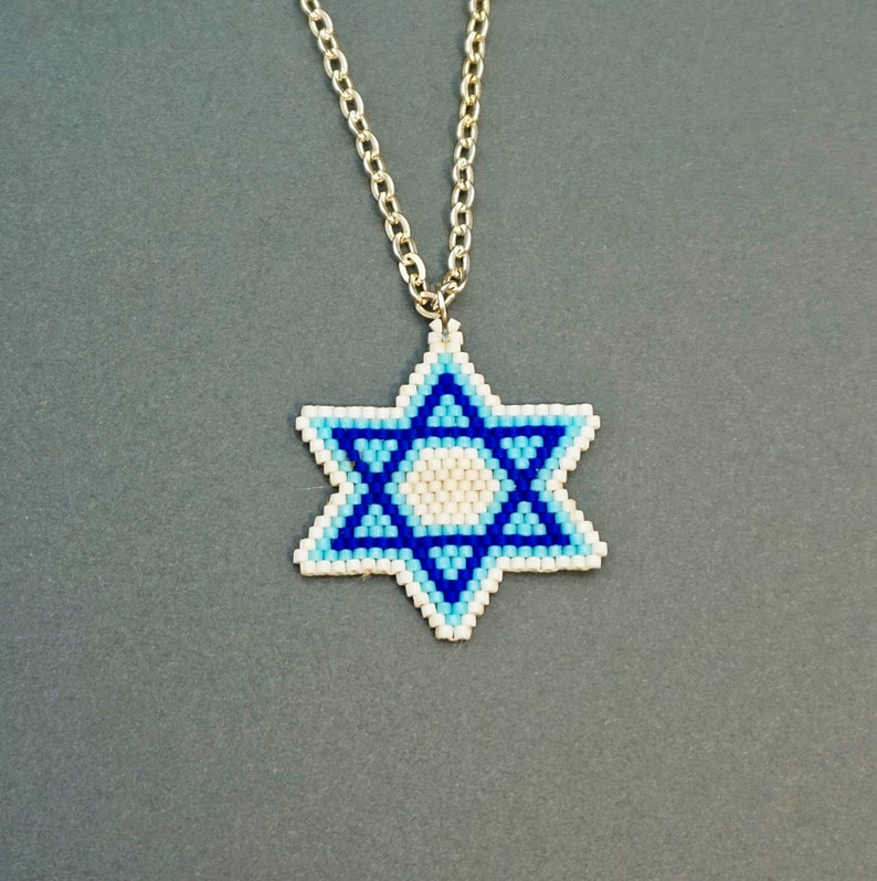 May include: A silver chain necklace with a blue and white beaded Star of David pendant.