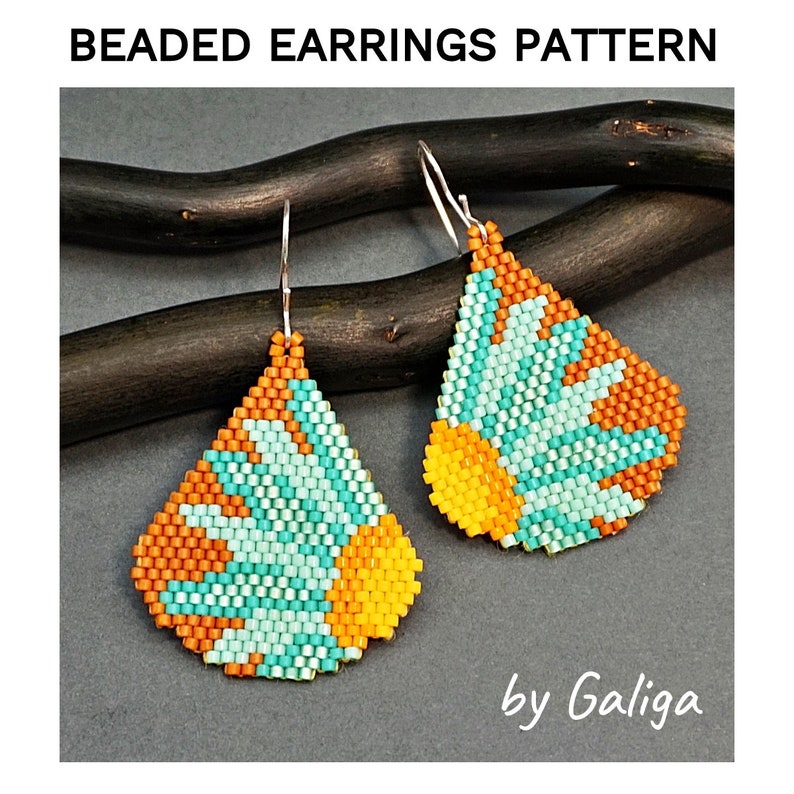 May include: A pair of beaded earrings with a geometric design in shades of orange, yellow, and turquoise. The earrings are hanging from silver hooks and are displayed against a dark wooden background. The text "by Galiga" is visible in the bottom right corner of the image.