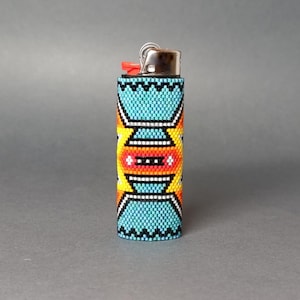 May include: A turquoise, yellow, orange, and white beaded lighter cover with a geometric pattern.