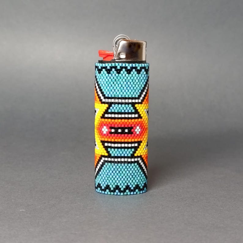 May include: A turquoise, yellow, orange, and white beaded lighter cover with a geometric pattern.
