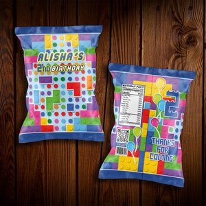 May include: Two colorful chip bags with a Lego theme. The front bag says "Alisha's 2nd Birthday". The back bag says "Birthday Fact" and "Thanks for coming".
