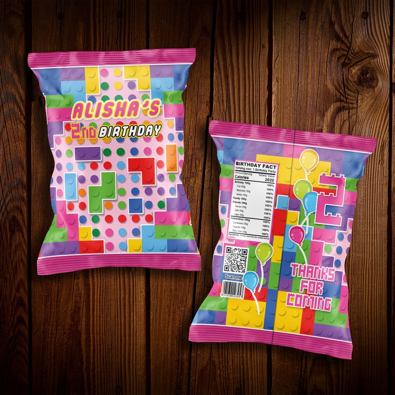 May include: Pink and colorful chip bag with a Lego theme. The front of the bag says "Alisha's 2nd Birthday". The back of the bag has a birthday fact and says "Thanks for coming".